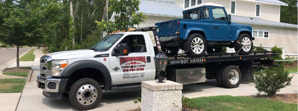 High end vehicle towing service with the Intercoastal rollback tow truck Geocode: @34.2608454,-77.8488667